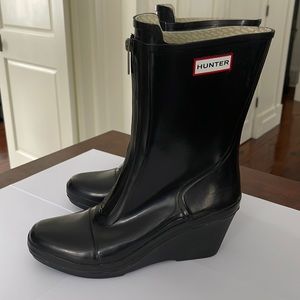 Black Hunter platform rain boots with front zipper.